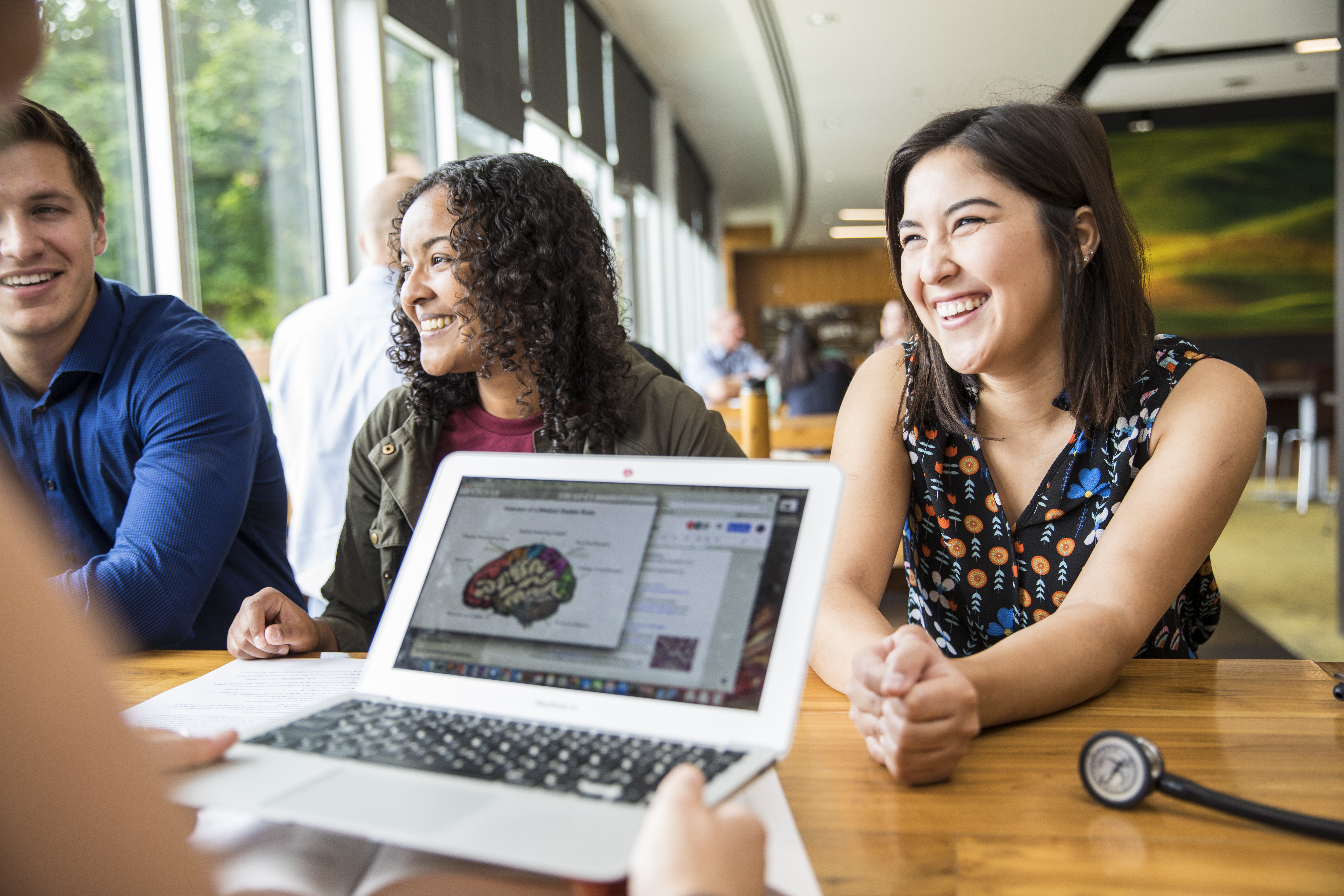 Students studying a picture of the brain