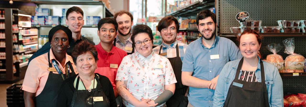 Smiling staff members from District Market
