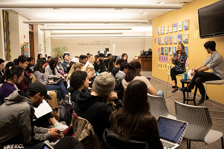 A Humanities Professor giving a lecture to a group of students.