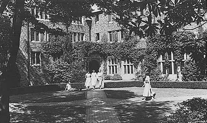 Women walking outside Hansee Hall in 1955