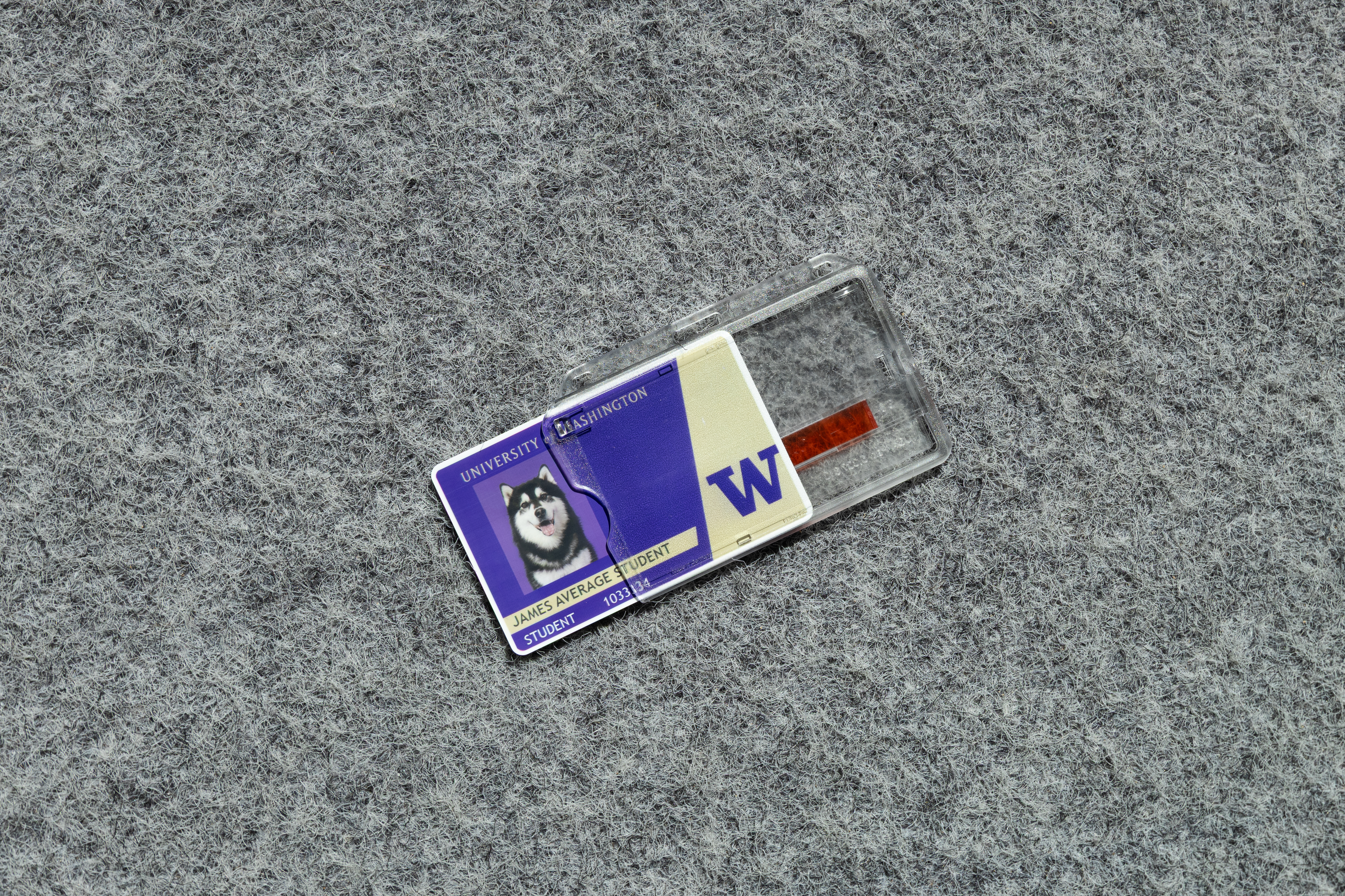 A clear, hard sided plastic cover with a red stripe and button to slide the card out for easy access. 