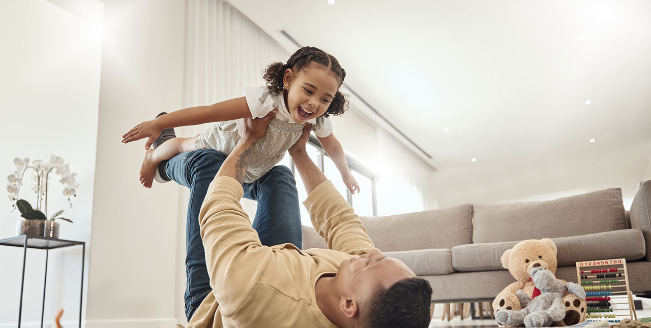 Father and Daughter Playing in Family Housing Unit
